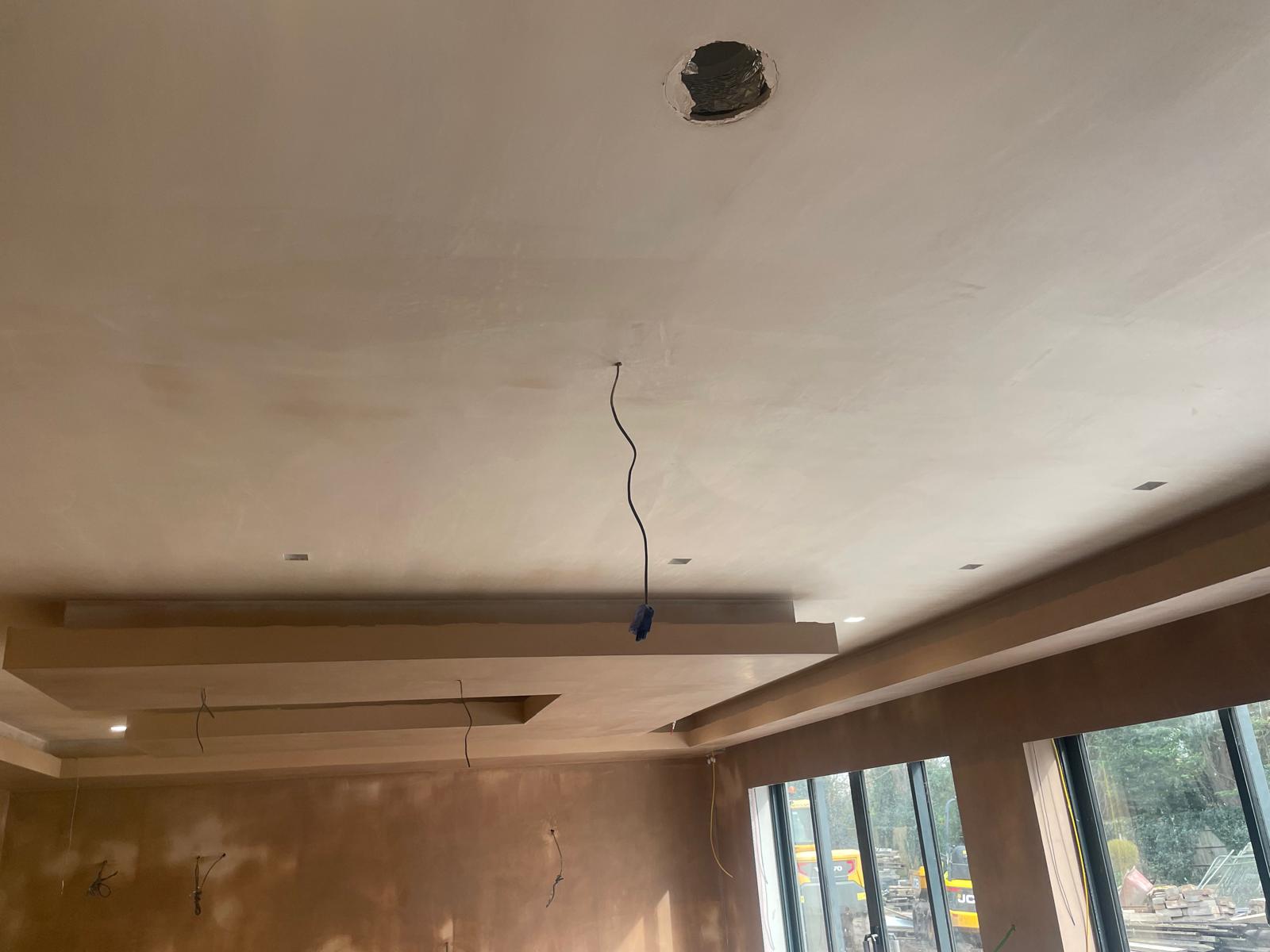 A freshly plastered room with a stepped ceiling